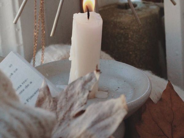 Minimalist still life with candle and leaves representing peace